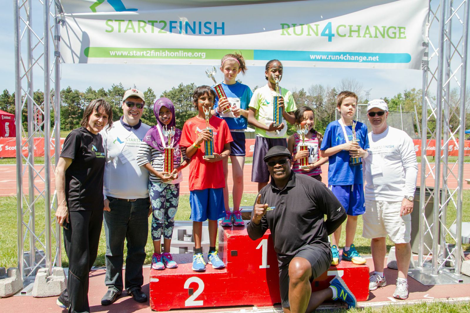 Coached by a children's author Fati (on the 1st place podium) wrote a book and won the 5k race